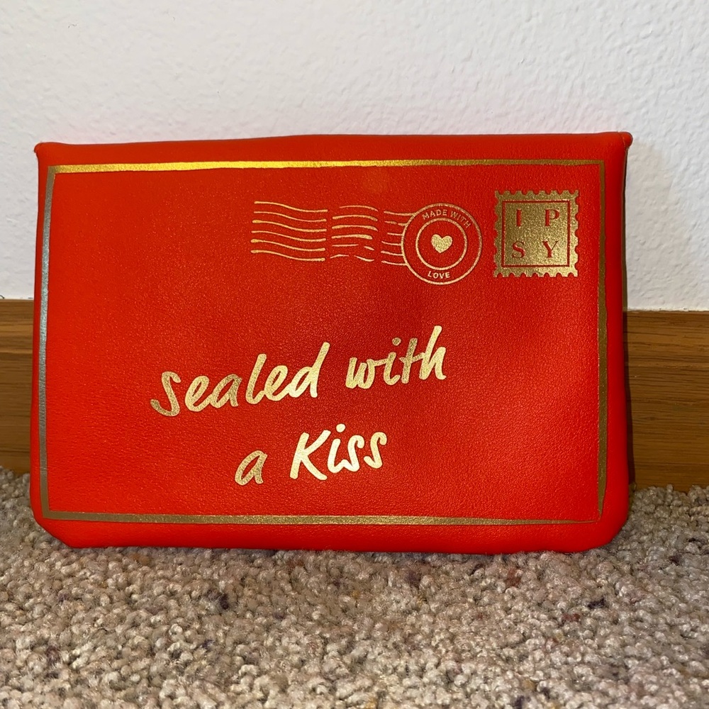 Brand: IPSY. Color: Red and gold.